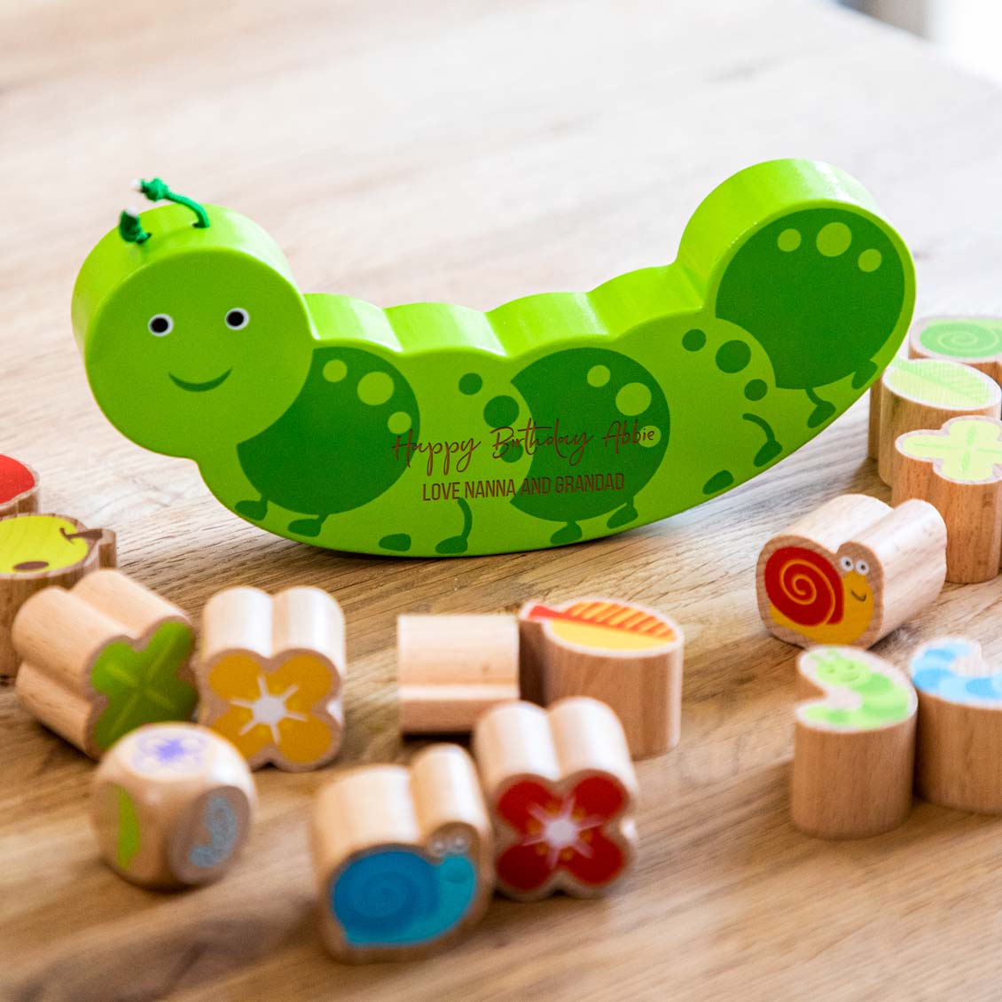 Wooden caterpillar balance game with pieces