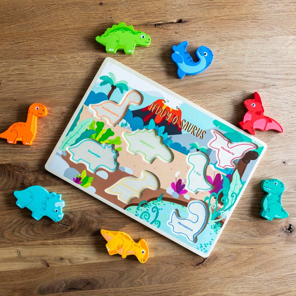 Wooden puzzle board with dinosaur puzzle pieces