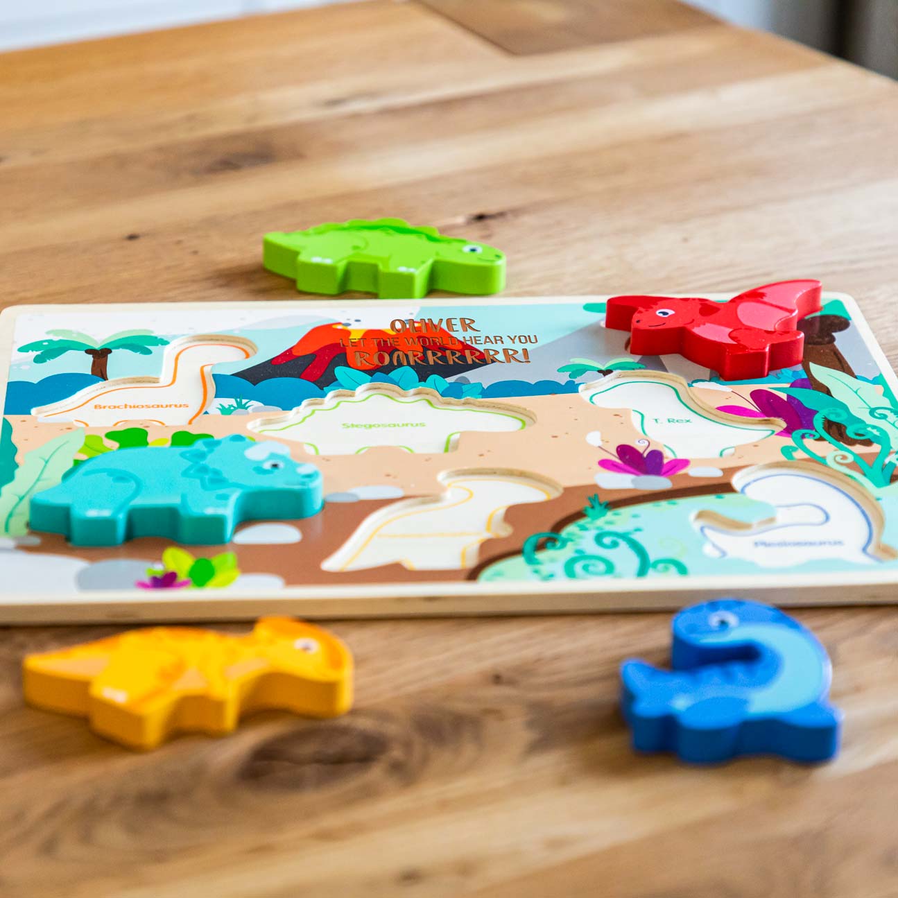 Close up of personalisation on wooden dinosaur puzzle