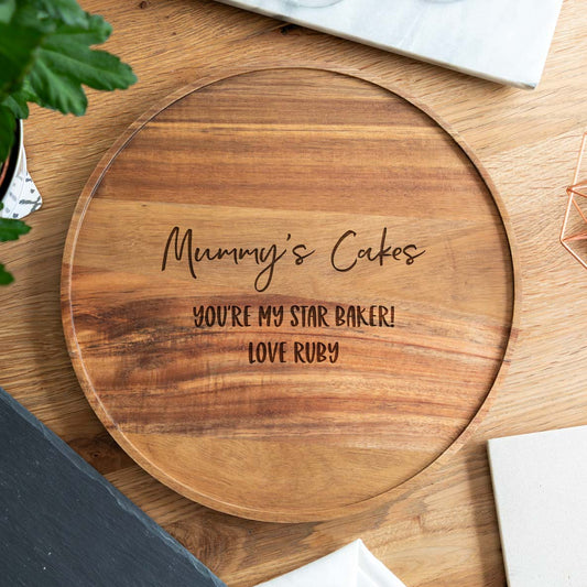 Wooden round cake board engraved with 'Mummy's Cakes you're my star baker' and a special message.