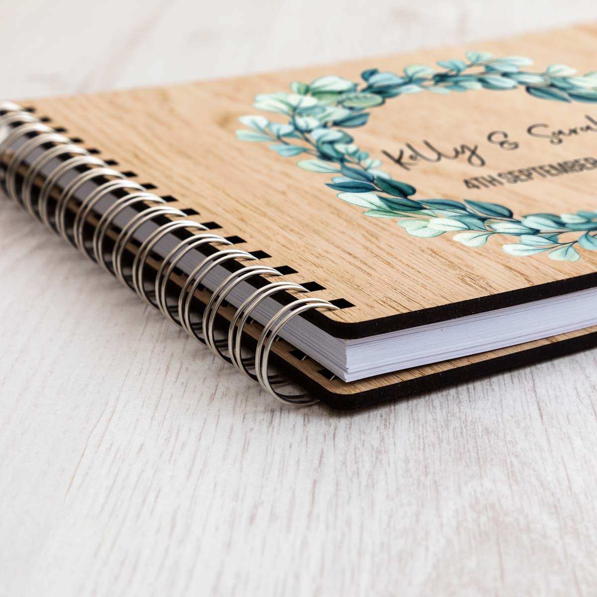 Close up of wedding guest book oak veneer cover