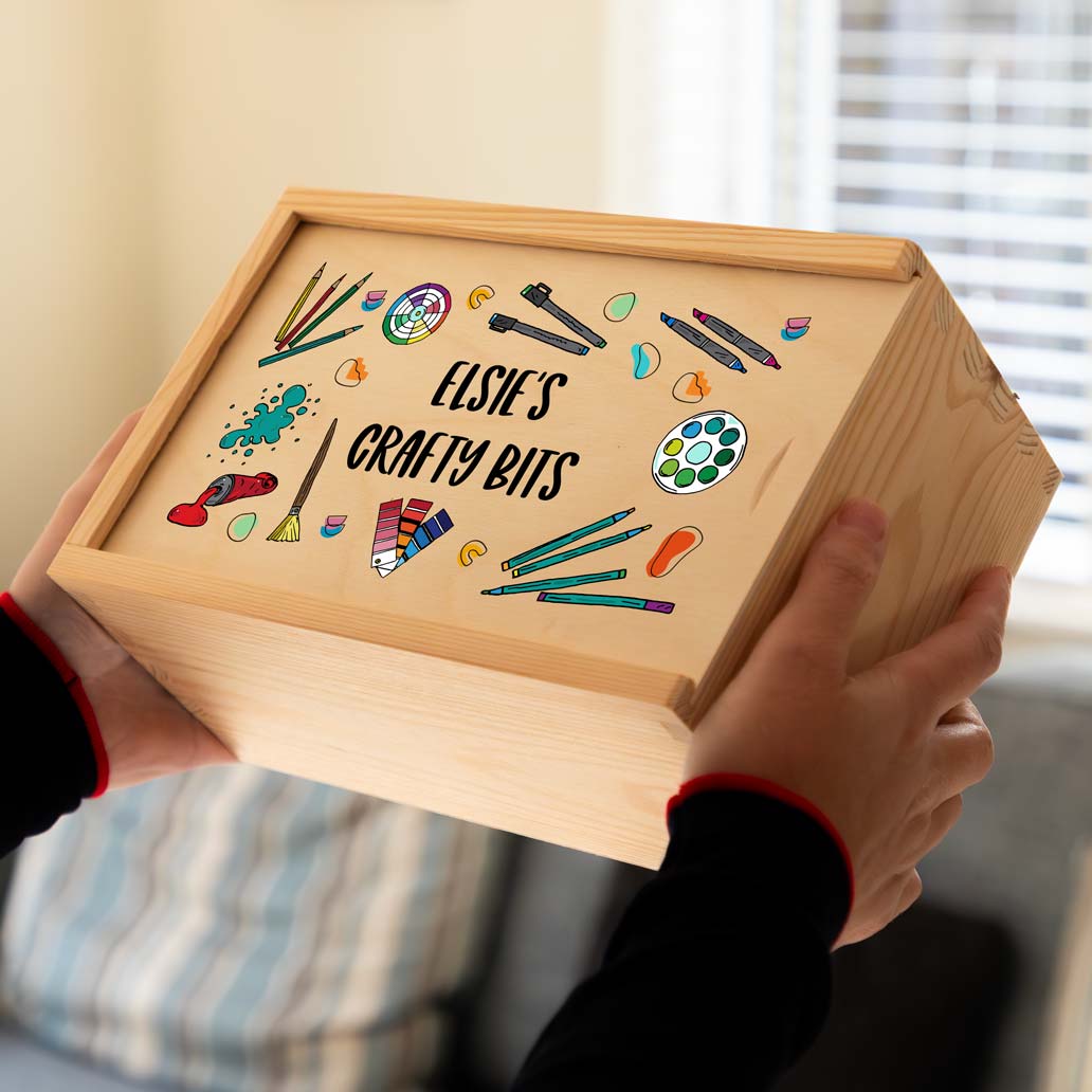 Wooden craft box with personalised text and craft supplies illustrations.