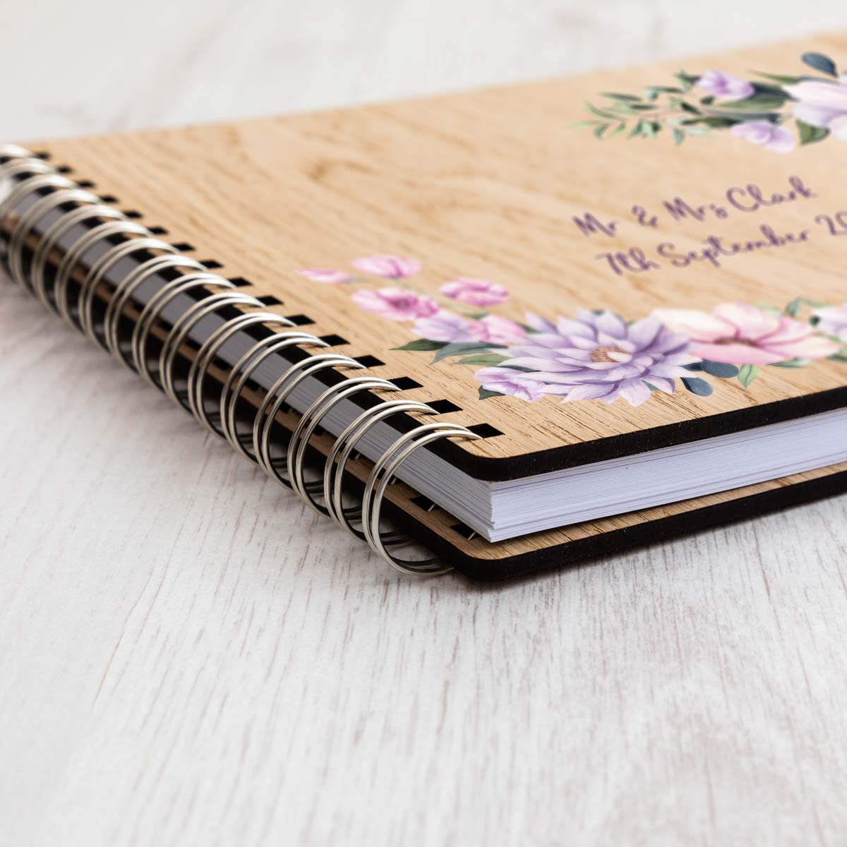 Close up of wedding guest book with floral corners design