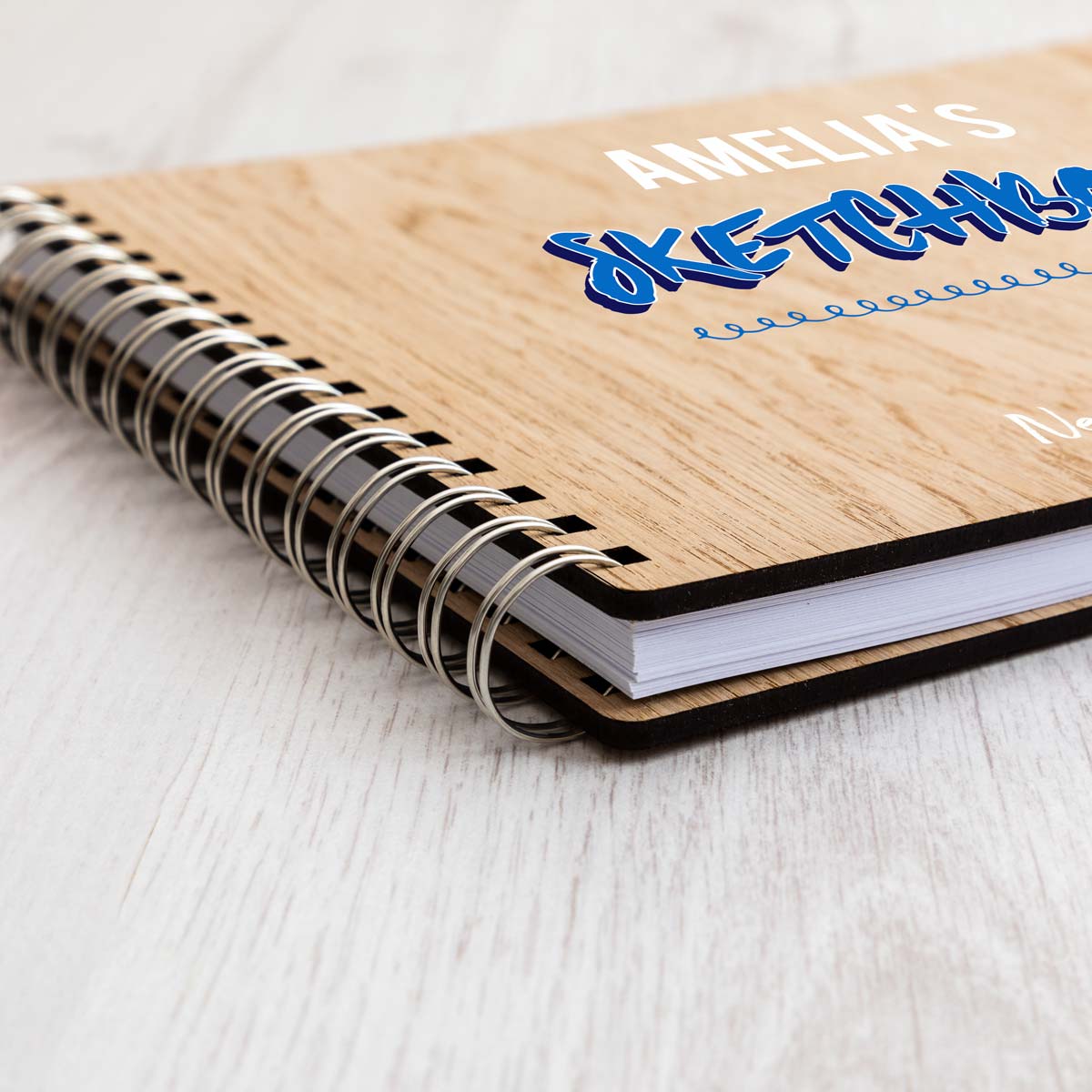 Close up of personalised sketchbbok with oak veneer covers