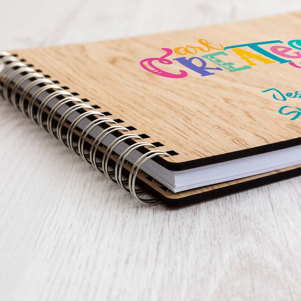 Close up of personalised sketchbook with oak veneer covers