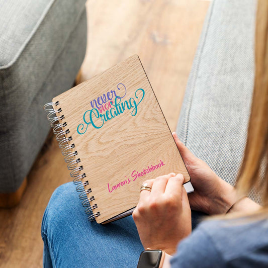 Personalised sketchbook with a printed design that says never stop creating