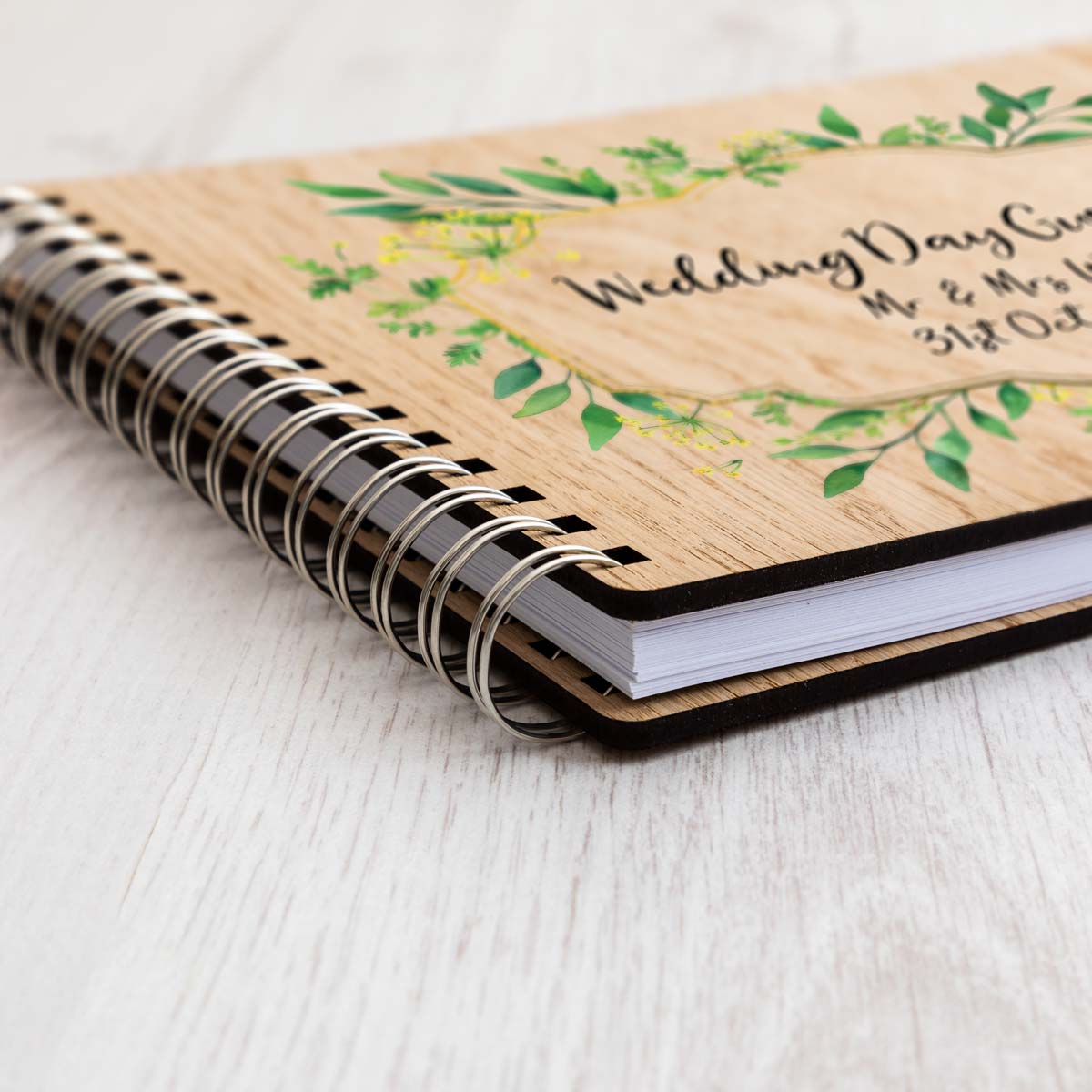 Close up of wedding day guest book oak veneer cover