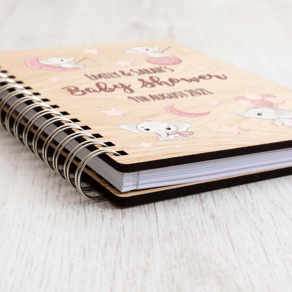Close up of baby shower guest book with pink elephant design
