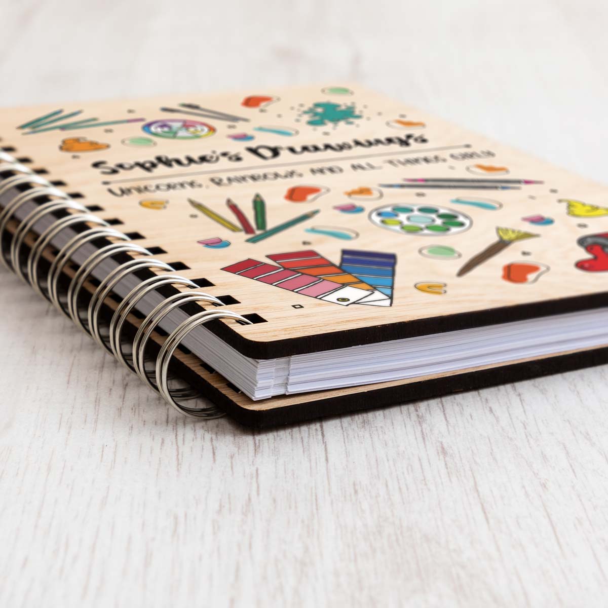 Close up of personalised sketchbook with oak veneer covers