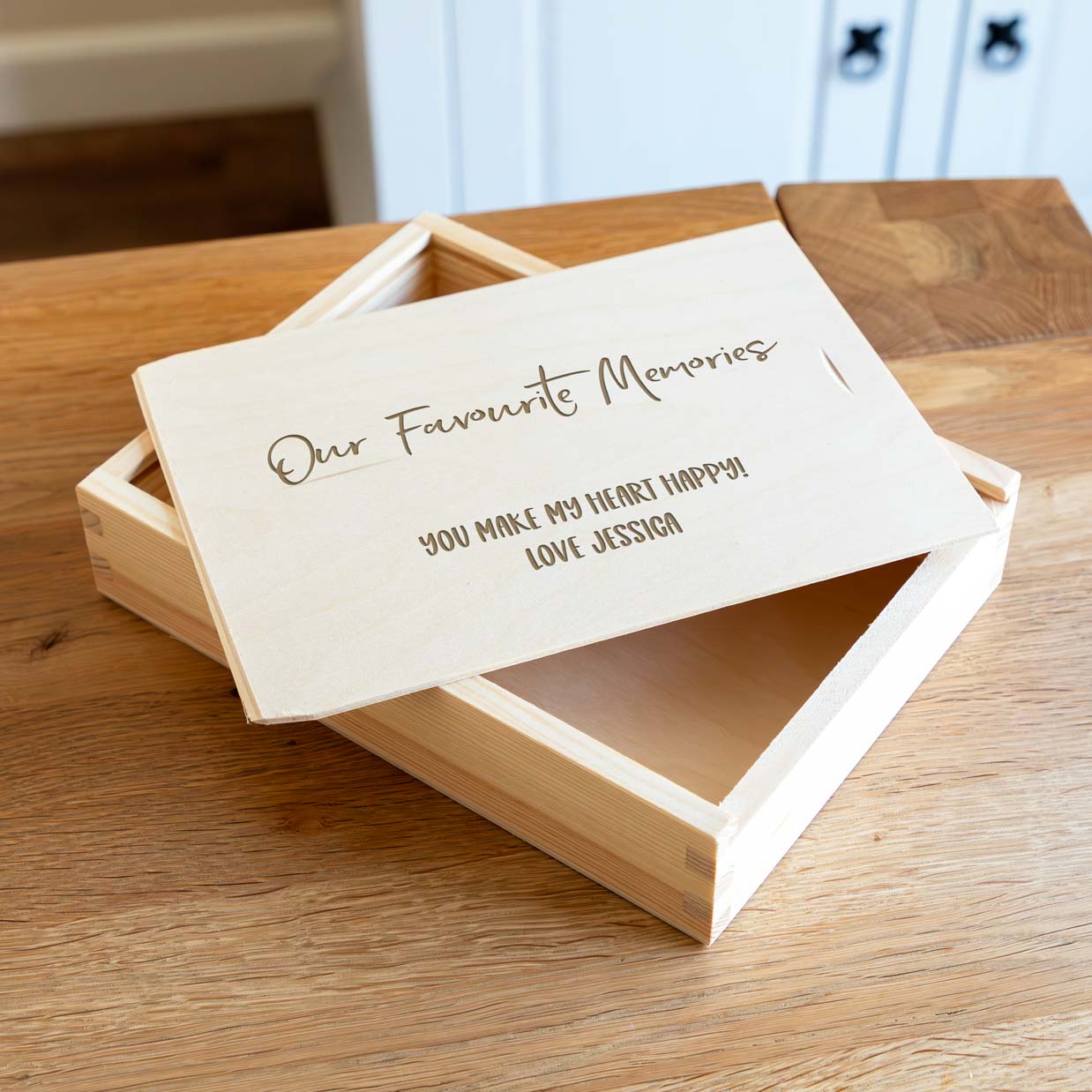 Wooden photo box engraved with 'Our Favourite Memories' and a personalised message on the sliding lid.