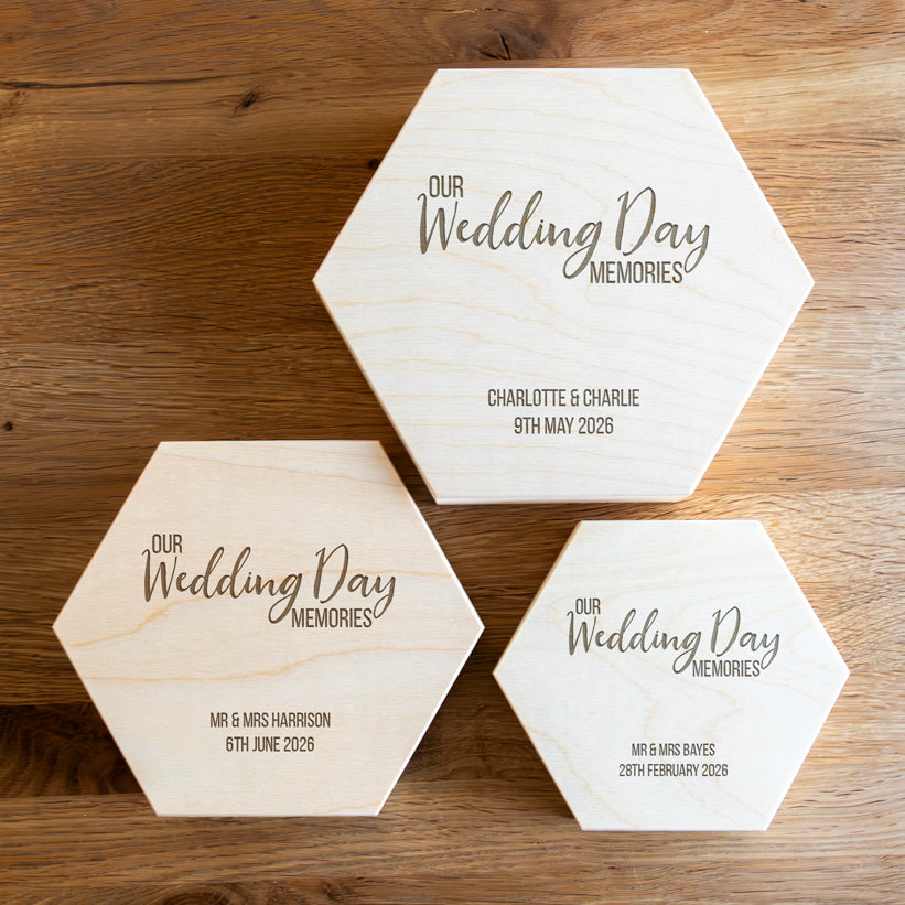 Three hexagonal wooden keepsake boxes in small, medium and large, engraved with 'Our Wedding Day Memories' and the personalised names and wedding date.