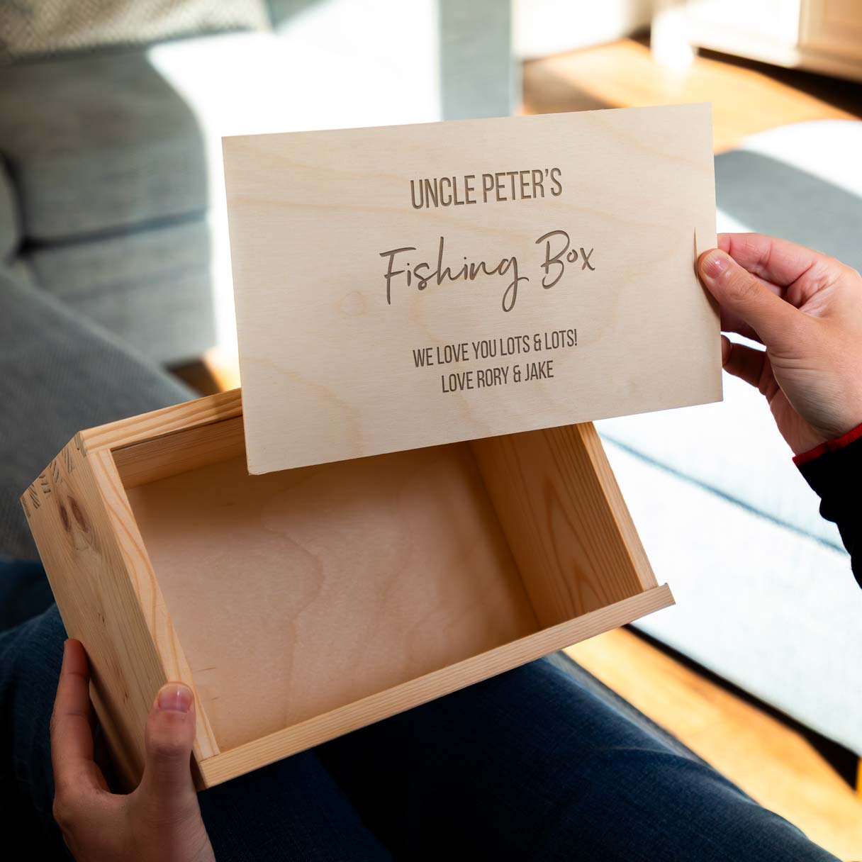 Wooden fishing box with a sliding lid that is engraved with personalised text.