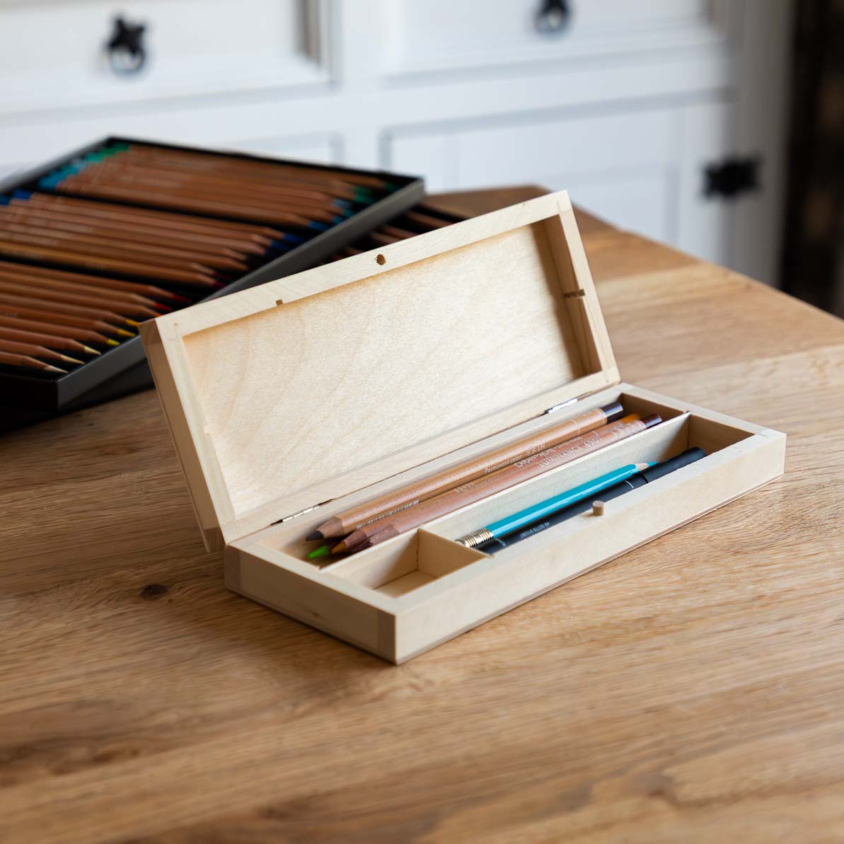 Wooden pencil case open pencils inside.
