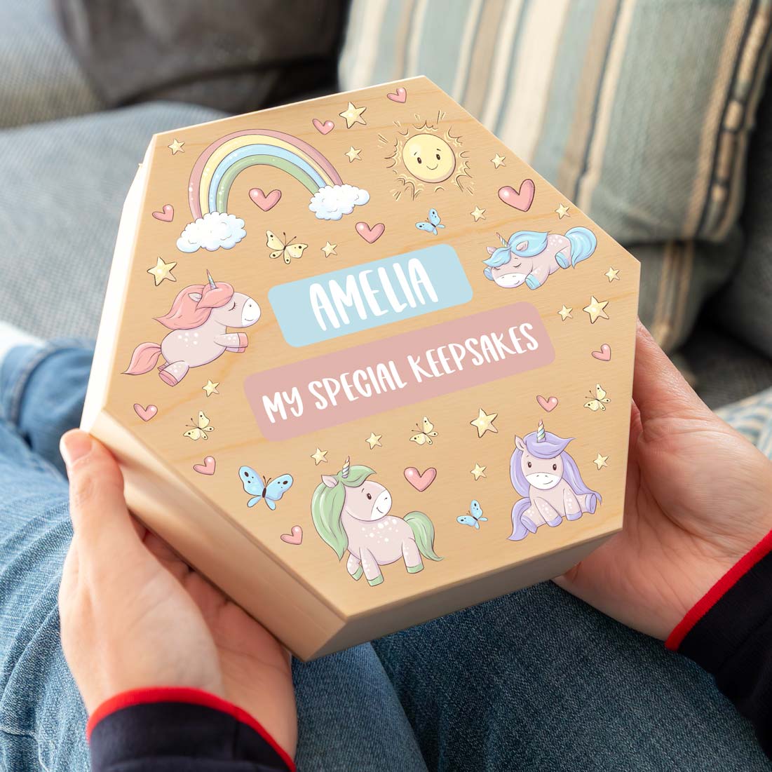Hexagonal wooden keepsake box with unicorn illustrations and personalised text.