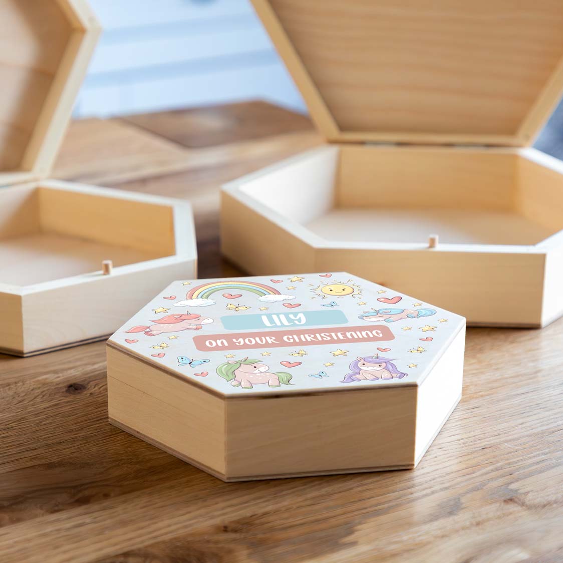 Wooden hexagonal keepsake box with unicorn design and personalised text to celebrate a christening.