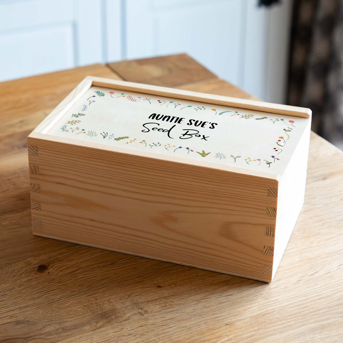 Wooden seed box with decorative sliding lid, printed with a wildflower design and personalised text.