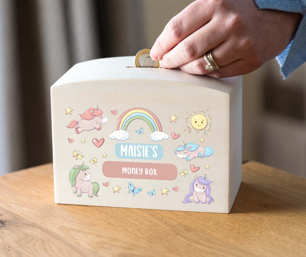 Children's money box with unicorn and rainbow design, personalised with a name and text.