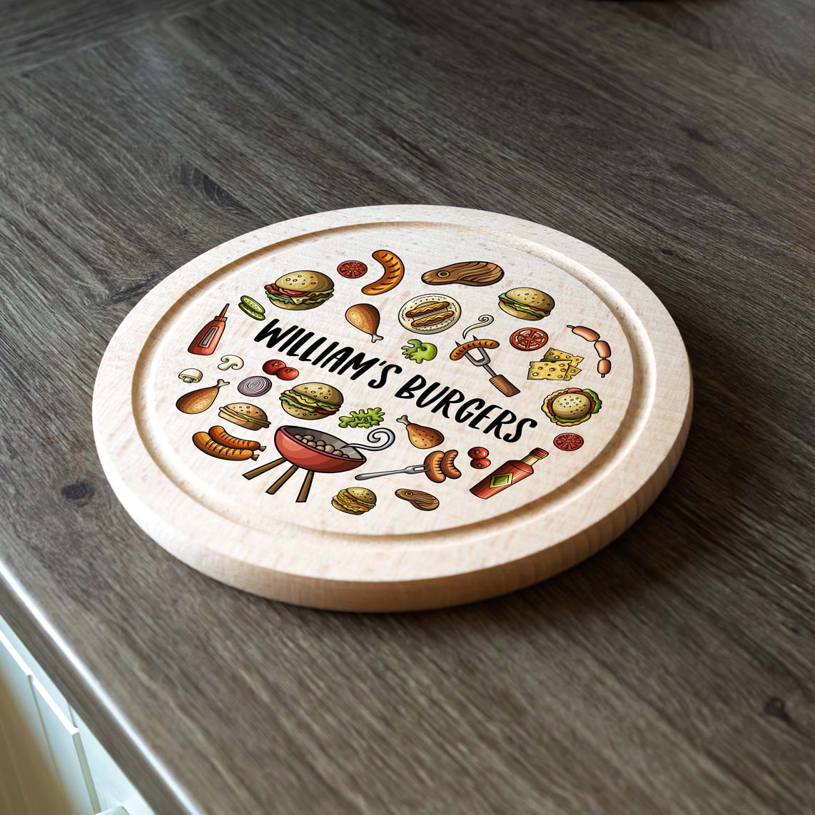 Round wooden serving board with BBQ-themed illustrations and 'Williams Burgers' personalised text on a wooden surface.