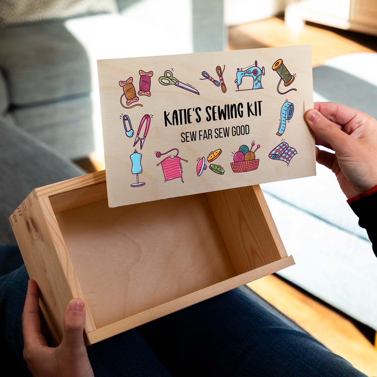 Wooden sewing kit box with a colourful design and personalised text.