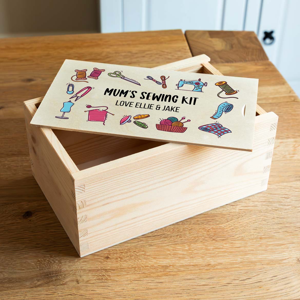 Wooden sewing box with a colourful sewing design and personalised text.
