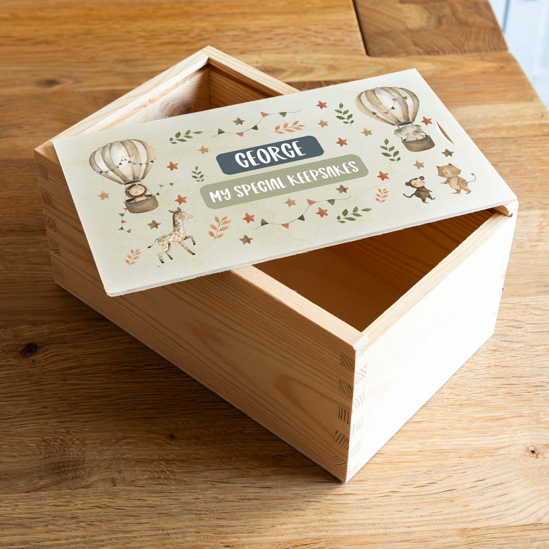 Wooden keepsake box with a decorative lid featuring safari animals and the personalised name and text.