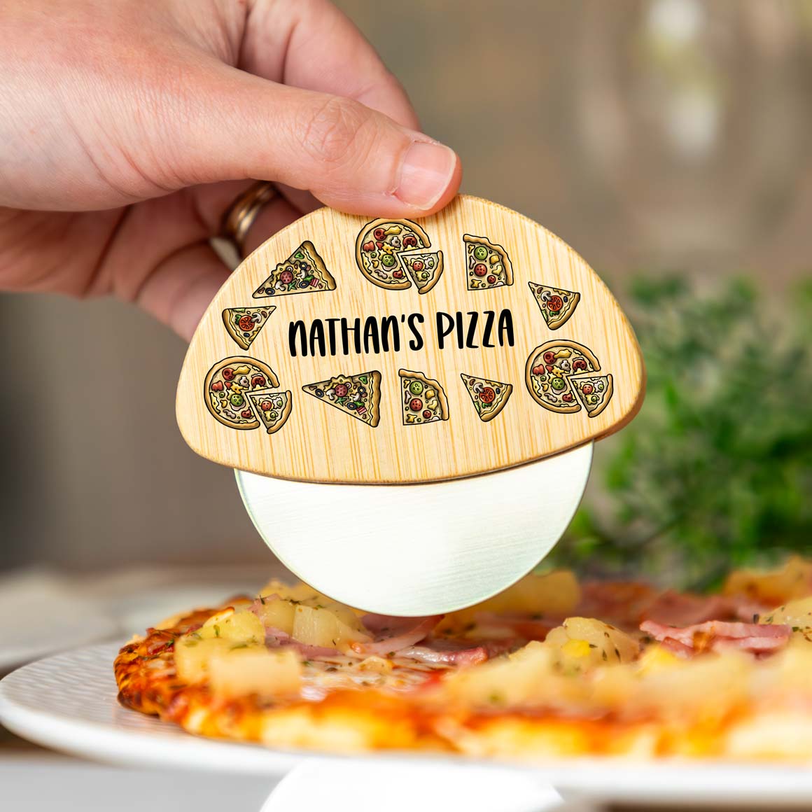 Wooden and stainless steel pizza cutter printed with pizza illustrations and personalised text.